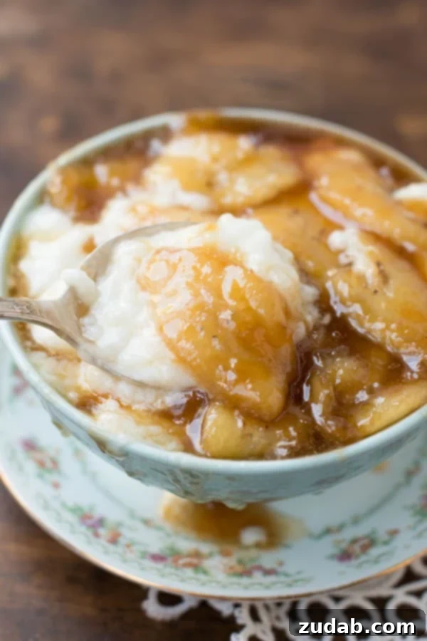 Indulgent Bananas Foster Sauce with Kozy Shack Rice Pudding Close-up of Bananas Foster topping for rice pudding, showing caramelized bananas and a rich sauce