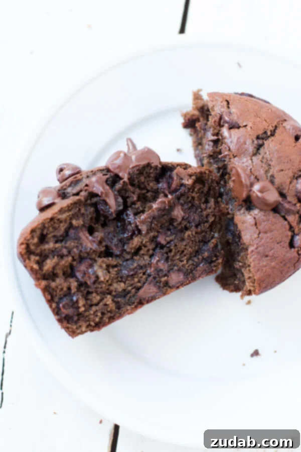 Double Chocolate Banana Muffins Prep: Ingredients Ready Freshly mashed ripe bananas, a bowl of dry ingredients, and chocolate chips laid out for baking double chocolate banana muffins.