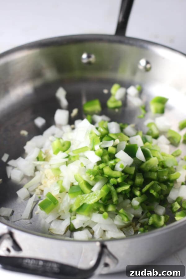 Skinny Healthy One Pot Chili Mac diced onion and green bell pepper in metal skillet