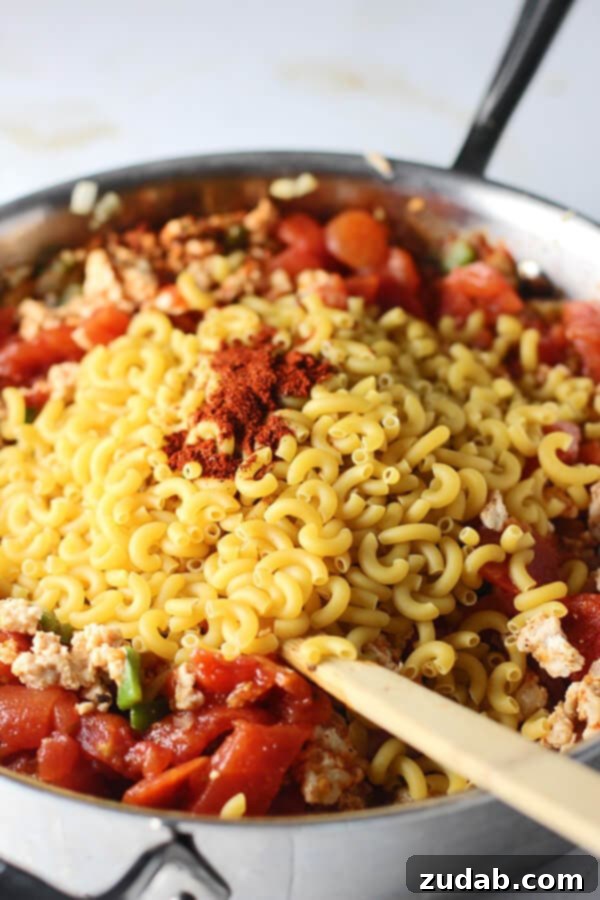 Skinny Healthy One Pot Chili Mac chili mac ingredients piled into a metal skillet