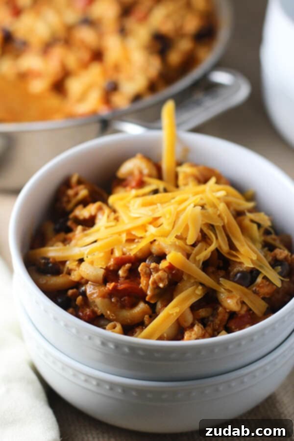 Skinny Healthy One Pot Chili Mac bowl of homemade chili mac topped with shredded cheese