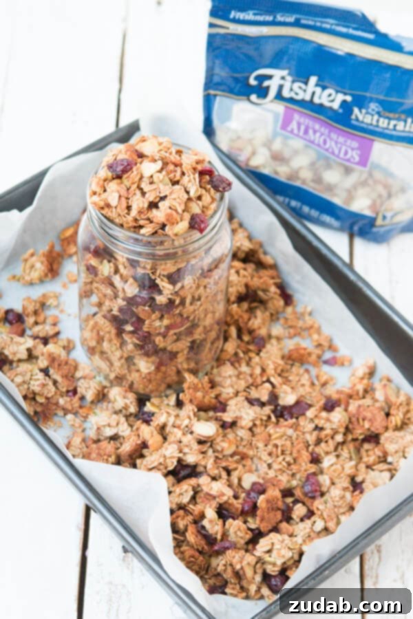 Handcrafted Strawberry Almond Granola 3 A bowl of freshly baked granola with scattered nuts and dried fruit, ready for breakfast.