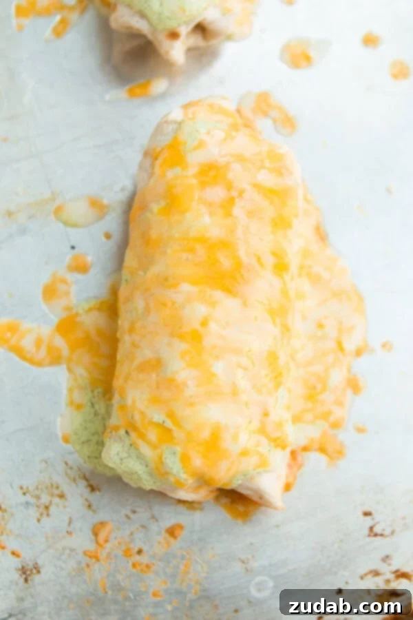 Our favorite smothered burritos cafe rio style ohsweetbasil.com Homemade Cafe Rio smothered chicken burritos topped with cheese