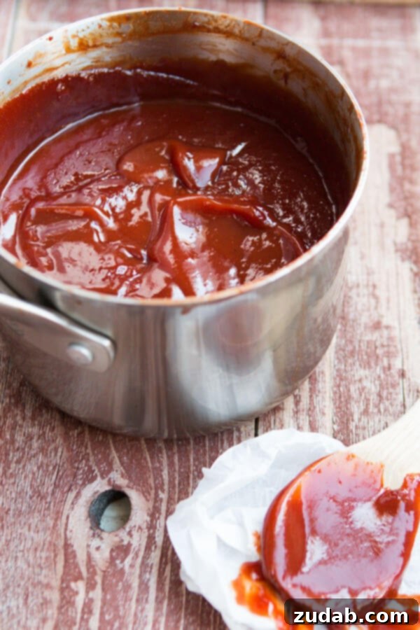 Homemade BBQ Sauce: Simmering to Perfection Close-up of a bubbling saucepan filled with rich homemade BBQ sauce simmering on the stove.