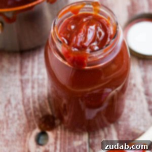 Thick, rich homemade BBQ sauce simmering in a saucepan, ready to be bottled.