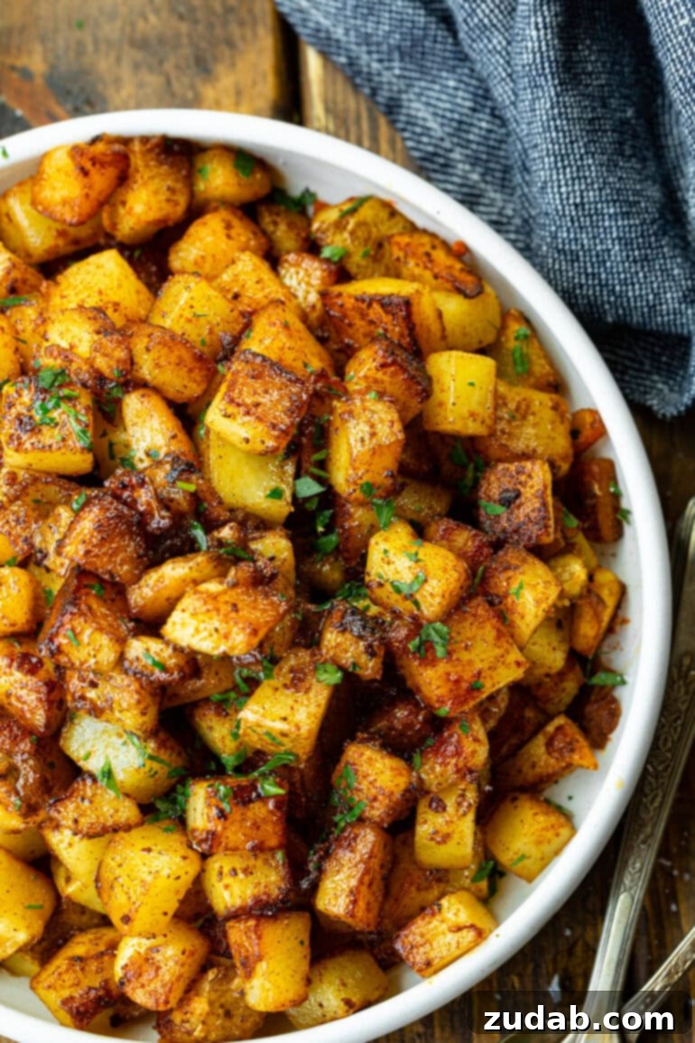 Smoky Fried Potatoes 2 a photo of a large serving bowl filled with crispy fried potatoes topped with fresh herbs
