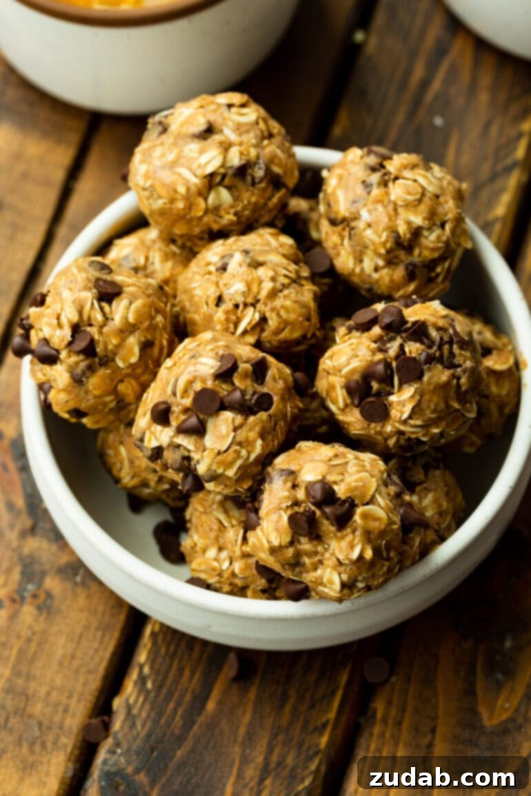 No-Bake Chocolate Protein Power Bites 6 A large white bowl generously filled with perfectly formed oatmeal protein balls, ready for enjoyment.