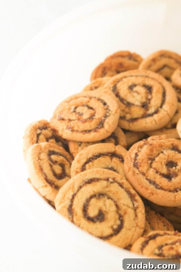 Grandma's Famous Pinwheel Cookies: A Classic, Easy-to-Make Recipe Perfect for Holidays and Family Gatherings A bowl overflowing with freshly baked Pinwheel Cookies, showcasing their distinct spiral pattern.