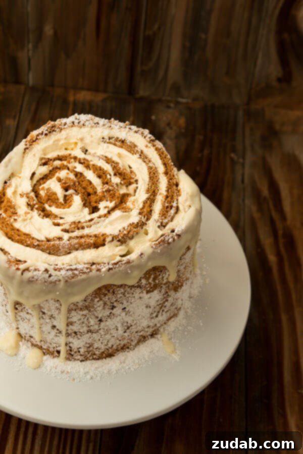 The Final Touch: White Chocolate Drizzle on Your Holiday Pumpkin Roll Cake A beautifully decorated Pumpkin Roll White Chocolate Cake with a delicate white chocolate drizzle, ready to serve.