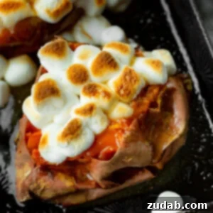 The Ultimate Homemade Texas Roadhouse Loaded Sweet Potato 8 a photo of a baked sweet potato topped with butter and toasted mini marshmallows