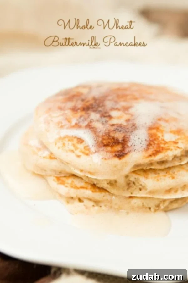 Whole wheat buttermilk pancakes for breakfast! ohsweetbasil.com Delicious stack of whole wheat buttermilk pancakes topped with fresh berries