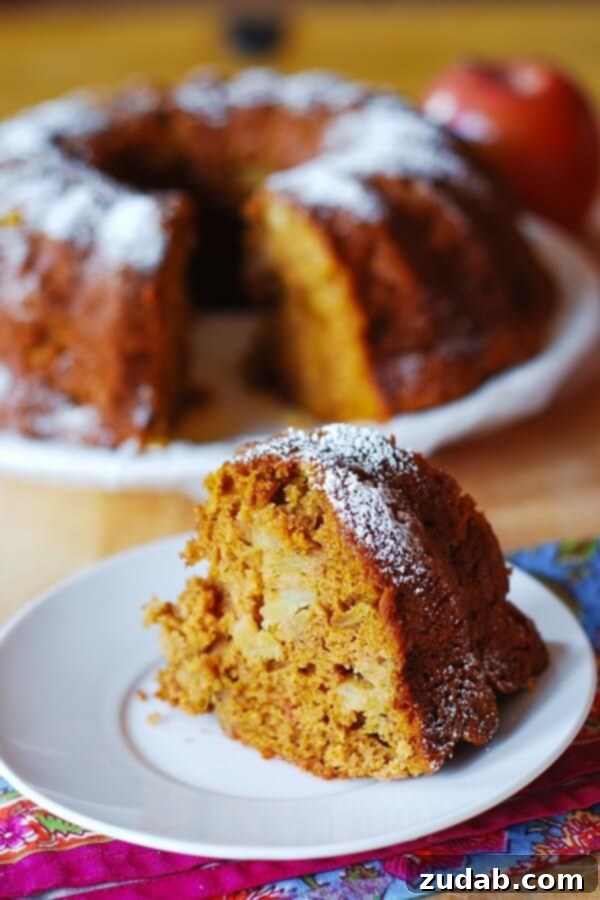Healthier Apple-Pumpkin Spice Bundt Cake for Guilt-Free Indulgence Beautifully baked Apple-Pumpkin Spice Bundt Cake, lightly dusted with powdered sugar