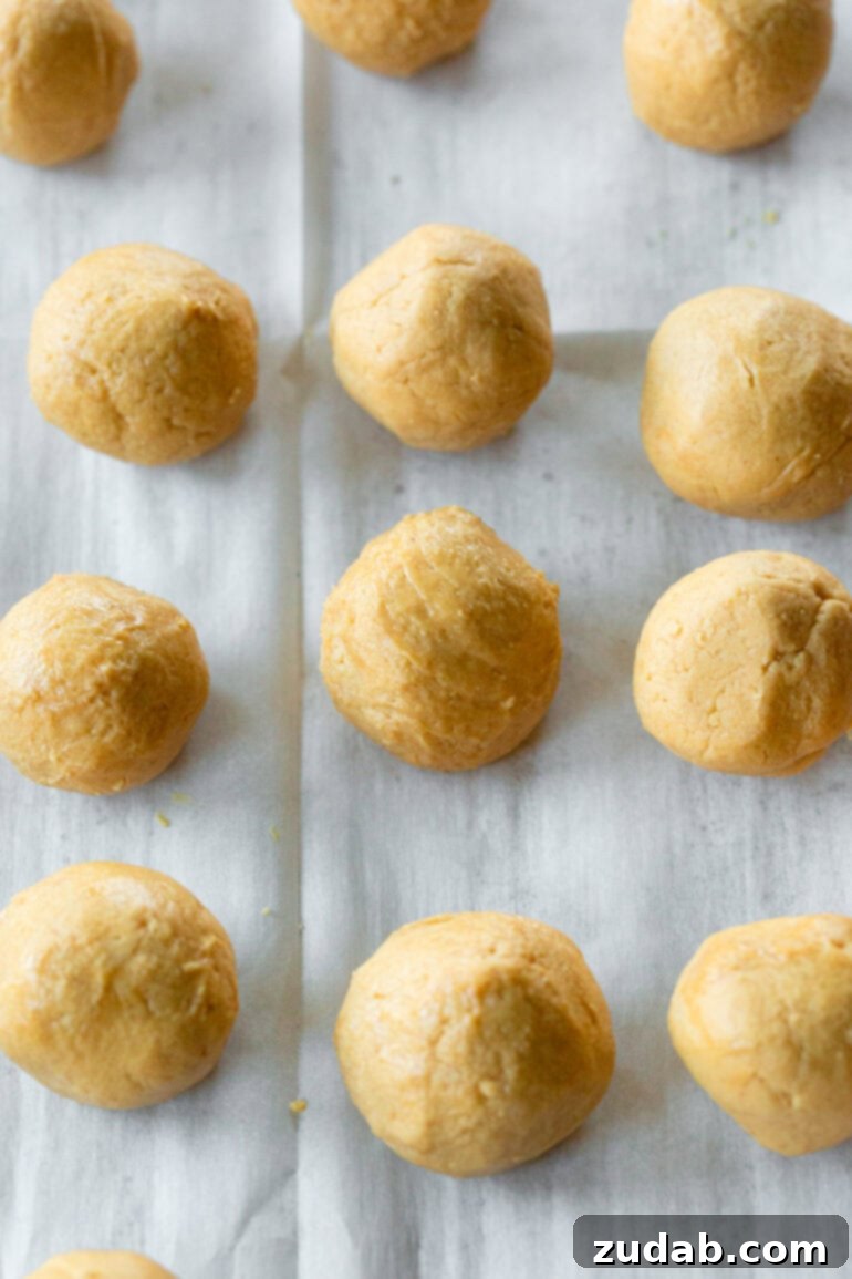 Peanut Butter Chocolate Bliss Bites 5 A glimpse of the ready-to-dip peanut butter truffle balls, neatly arranged on parchment paper before their chocolate transformation.