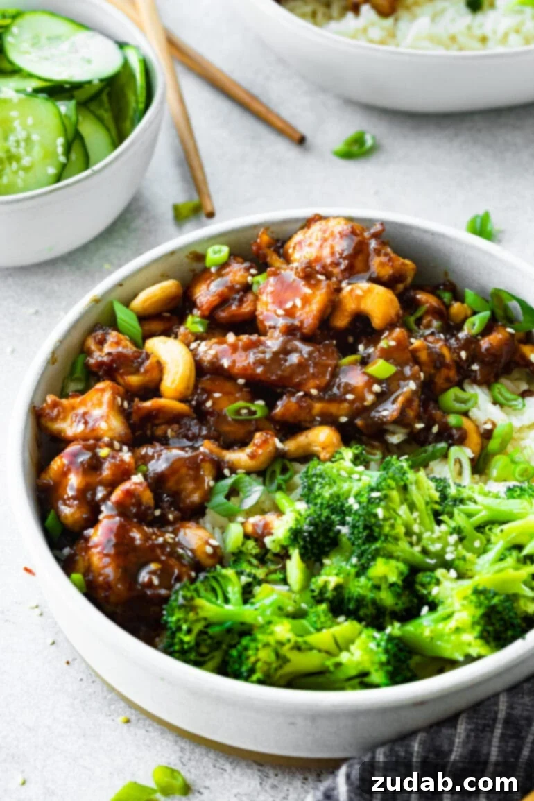 Effortless Cashew Chicken 6 A photo golden cooked chunks of meat coated in a sweet sticky sauce and mixed with roasted nuts served with steamed broccoli, just like your favorite takeout.