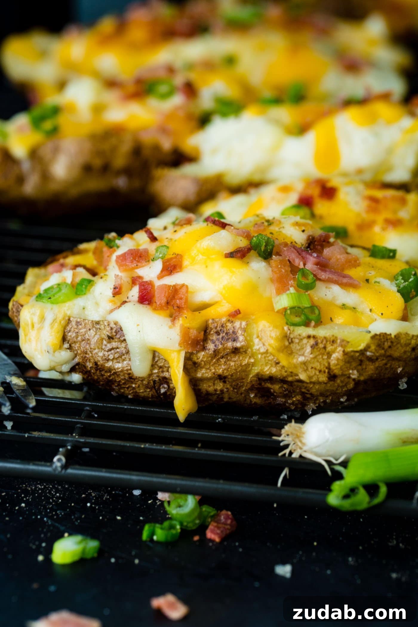 Twice-Baked Potato Perfection 2 a cooling rack with cheesy topped twice baked potatoes and bacon crumbles
