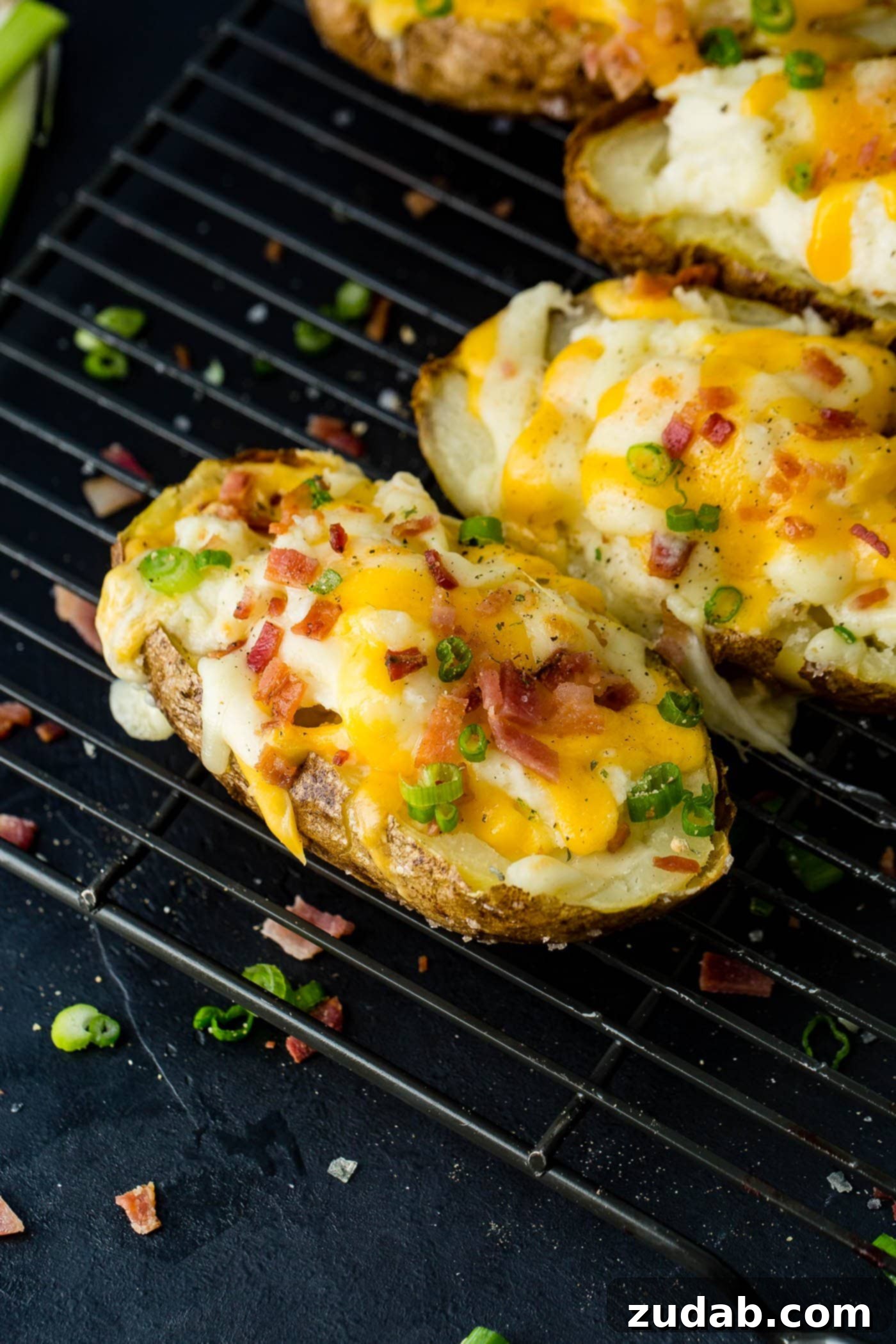 Twice-Baked Potato Perfection 4 a cooling rack with a line up of twice baked potatoes loaded with bacon and cheese