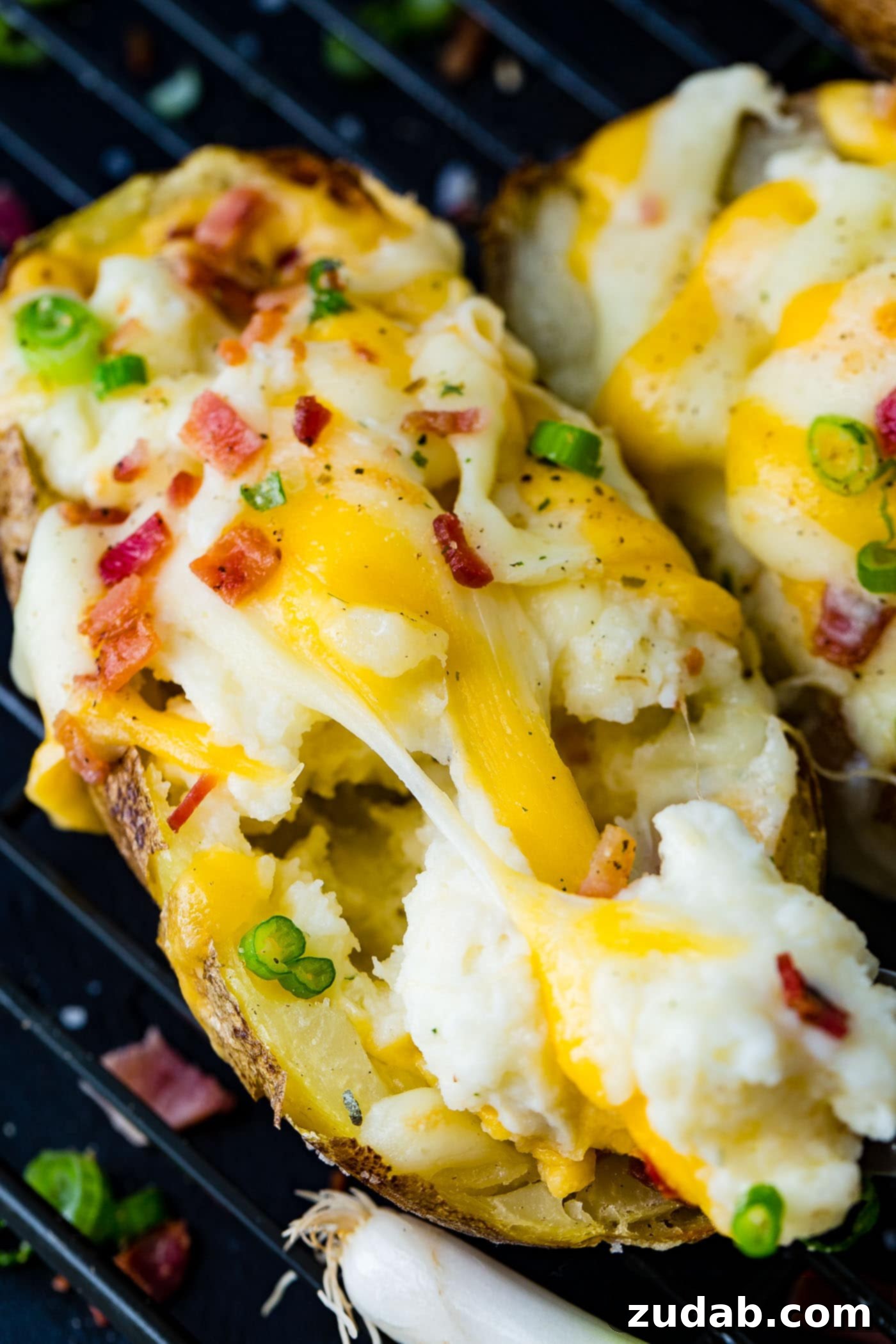 Twice-Baked Potato Perfection 5 a cooling rack with a line up of twice baked potatoes loaded with bacon and cheese