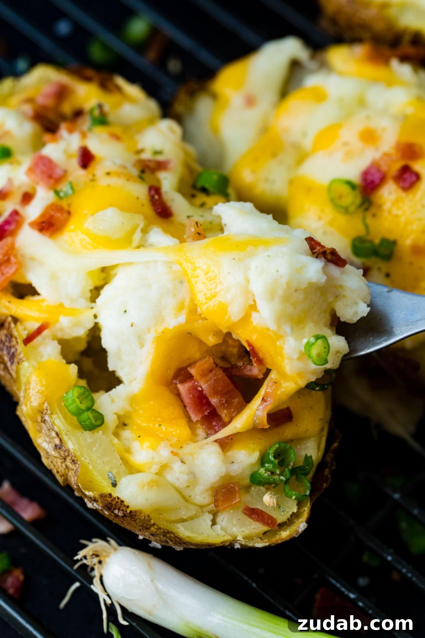 Twice-Baked Potato Perfection 6 a cooling rack with a line up of twice baked potatoes loaded with bacon and cheese