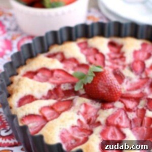Luscious Strawberry Cake 2 Strawberry Cake - this from scratch cake is cooked with layered strawberries for a stunning, lightly sweet cake that is best served with a side of sweetened coconut whipped cream.