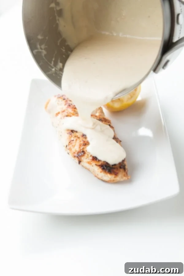 Savory Grilled Chicken with Tangy Lemon Sauce Close-up of juicy grilled chicken with creamy lemon sauce.