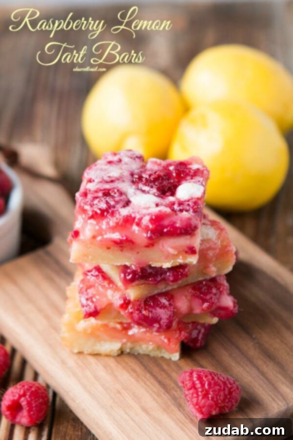 Irresistible Raspberry Lemon Bars A photo of several raspberry lemon bars stacked on a wooden cutting board