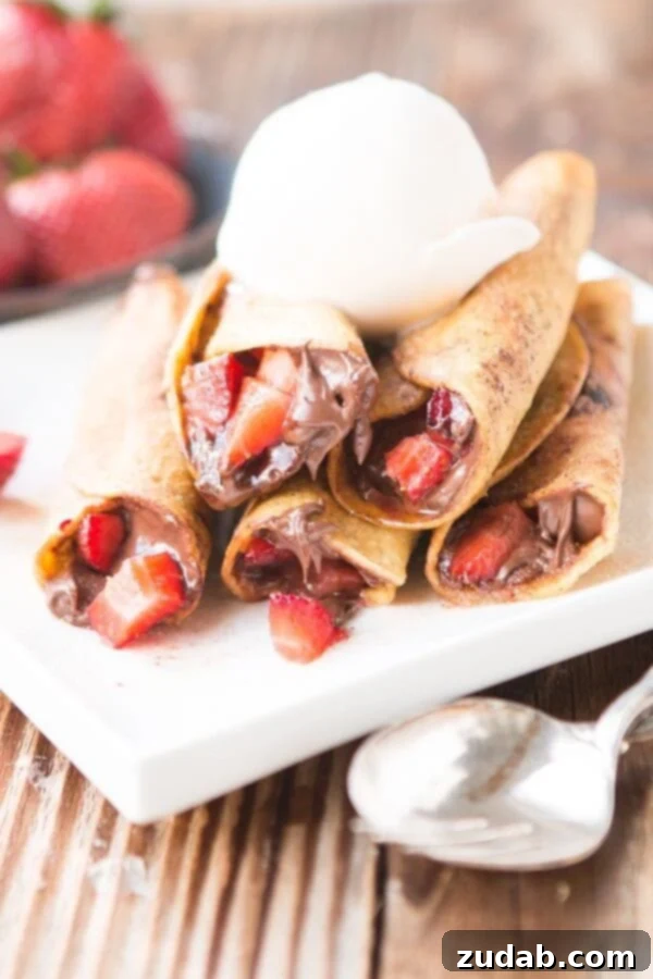 Nutella Strawberry Taquitos deep fried and rolled in cinnamon sugar ohsweetbasil.com Golden-brown Nutella Strawberry Taquitos, fresh from the fryer and dusted with sweet cinnamon sugar.
