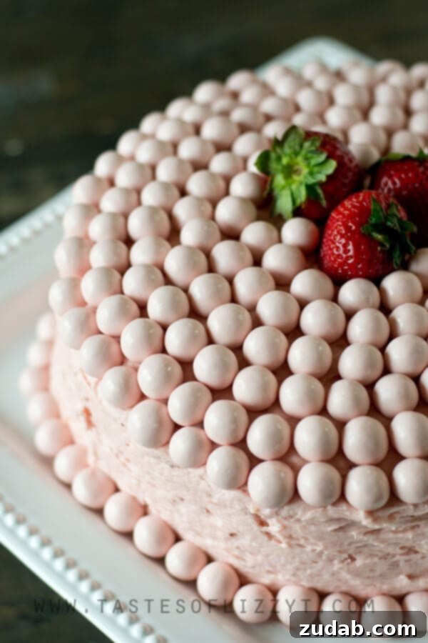 Vanilla Malt Cake with Strawberry Buttercream Close-up of a slice of Strawberry Malted Milkshake Cake revealing layers of moist vanilla malt cake and pink strawberry buttercream.