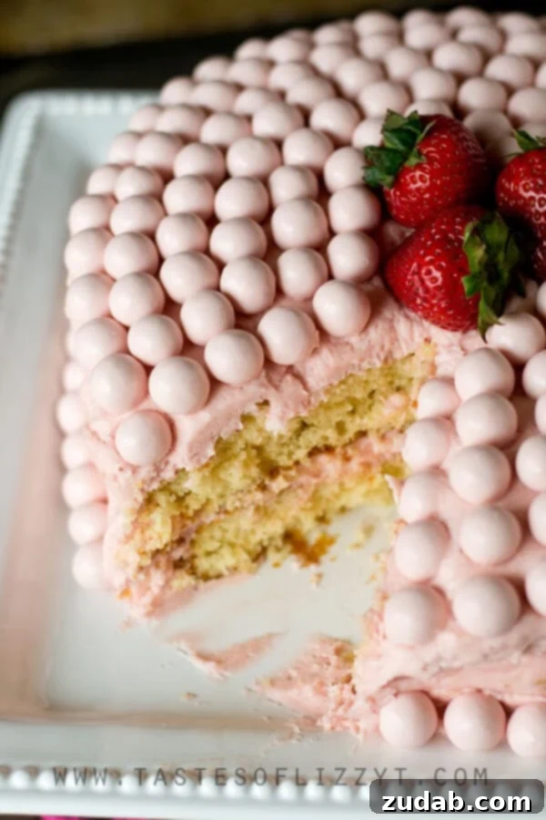 Decadent Strawberry Malted Milkshake Cake Frosting A beautifully frosted Strawberry Malted Milkshake Cake, emphasizing the smooth, pink homemade buttercream.