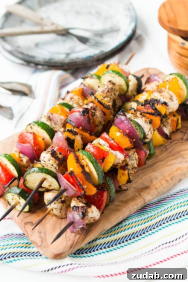 Vibrant Tuscan grilled chicken kabobs with fresh vegetables, perfect for a healthy summer meal. Low-carb, gluten-free, grain-free.