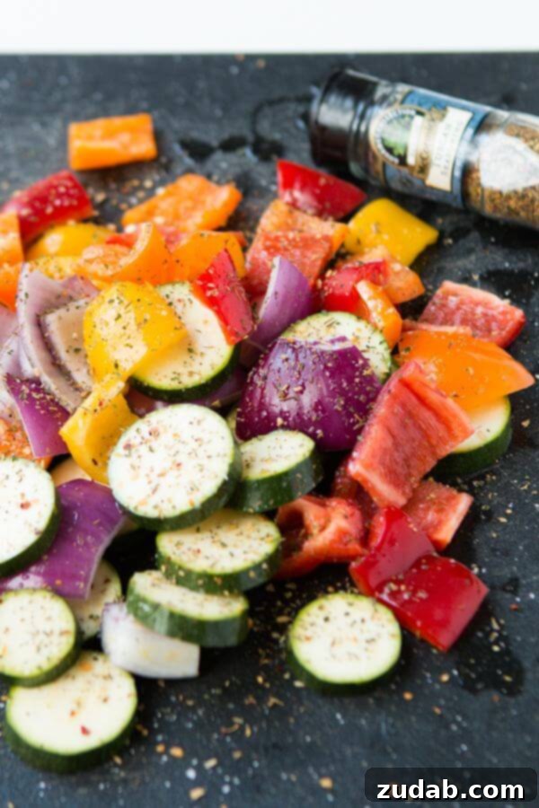 Close-up of perfectly grilled Tuscan chicken kabobs, showcasing the tender chicken and colorful, charred vegetables.