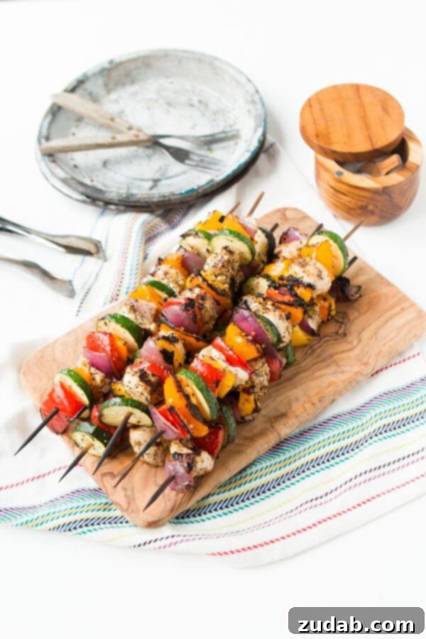Arrangement of Tuscan chicken kabobs with fresh lemon slices, ready for grilling or serving.
