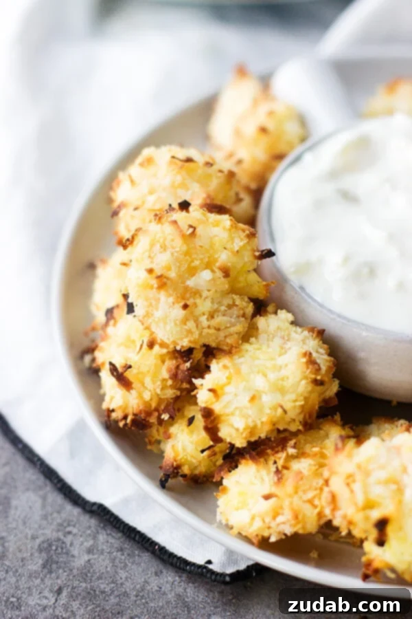 Perfectly Baked Coconut Shrimp for a Healthy Meal Three Baked Coconut Shrimp with Tropical Dipping Sauce ready to eat