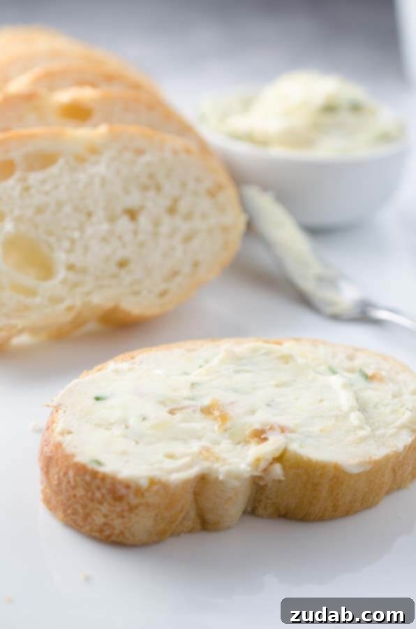 Roasted Garlic & Rosemary Whipped Butter A serving of Roasted Garlic & Rosemary Whipped Butter with fresh rosemary sprigs.