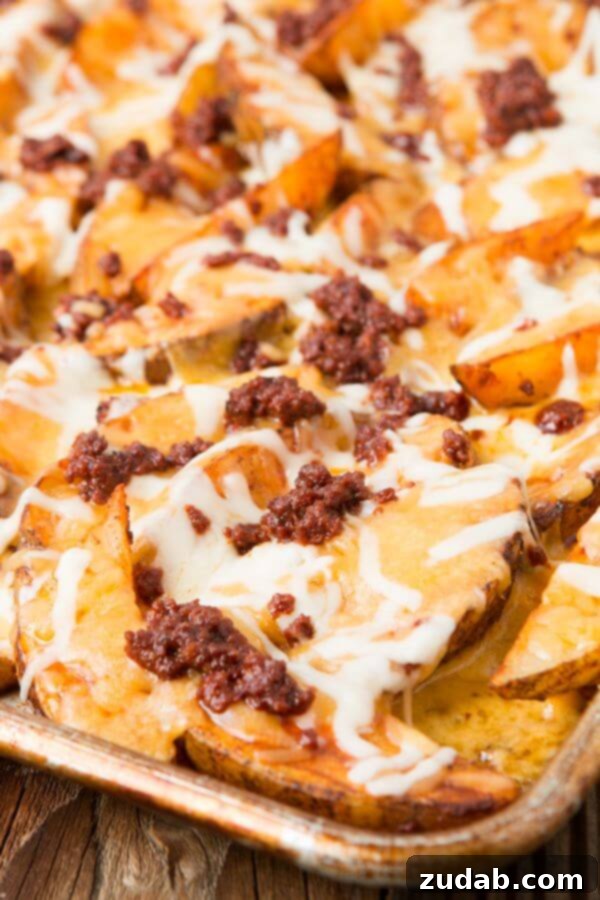 Indulgent cheesy potatoes with a savory chorizo topping. Close-up of Chorizo Loaded Cheesy Potatoes with melted cheese.