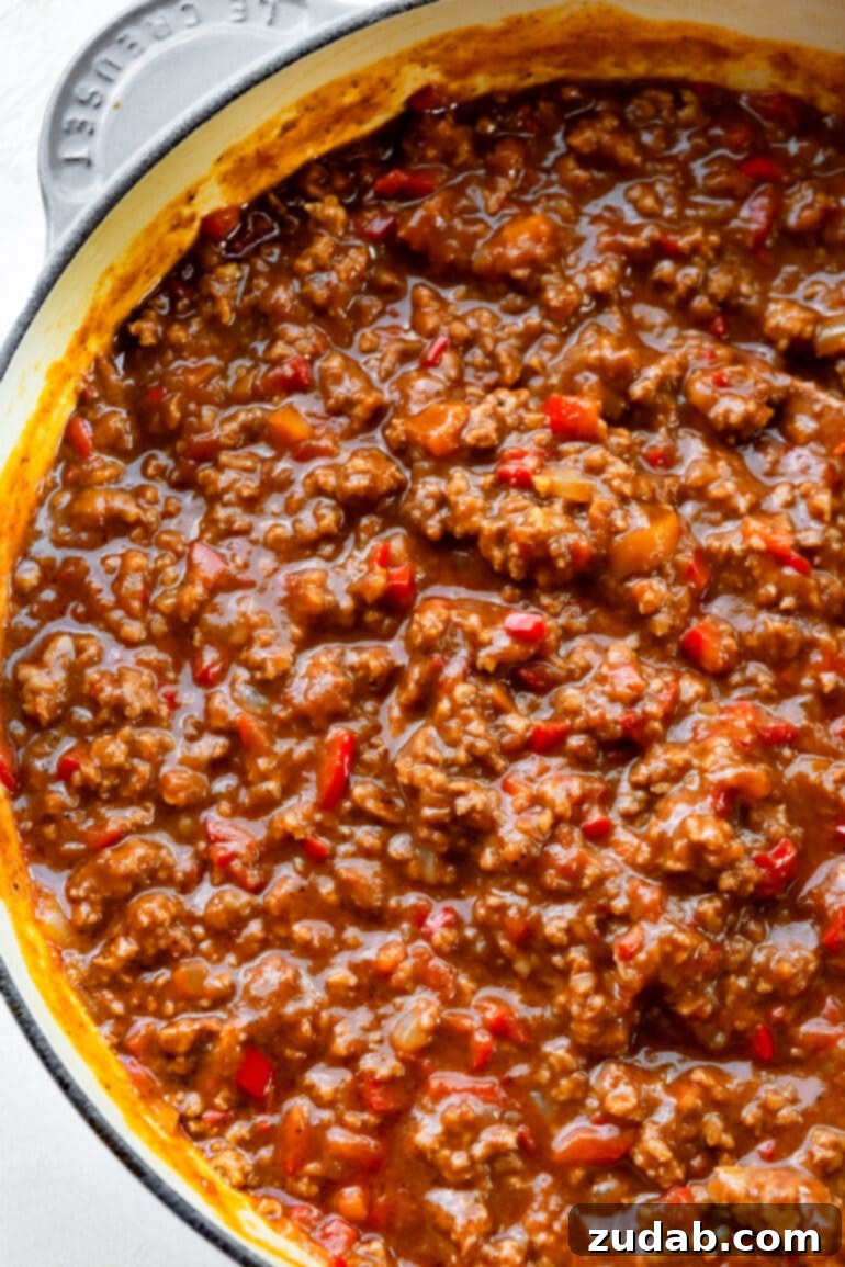 The Ultimate Sloppy Joe Recipe 7 A Dutch oven filled with a generous amount of saucy ground beef sloppy joe filling, highlighting its rich texture and inviting appearance.