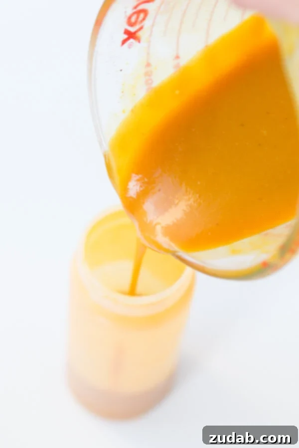 Perfectly crafted Carolina Mustard BBQ Sauce – a must-have for Southern barbecue. A close-up of a jar of rich, golden Carolina Mustard BBQ Sauce, ready to be served.