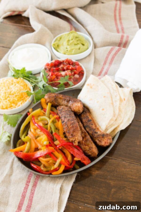 Close-up of juicy Italian sausage strips, bell peppers, and onions ready for fajitas.