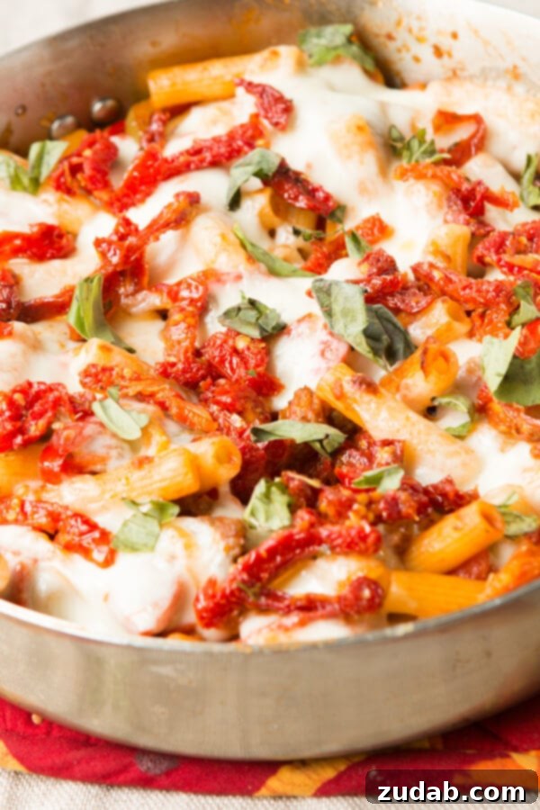 Hearty Italian Sausage Pasta with perfectly caramelized onions and peppers.
