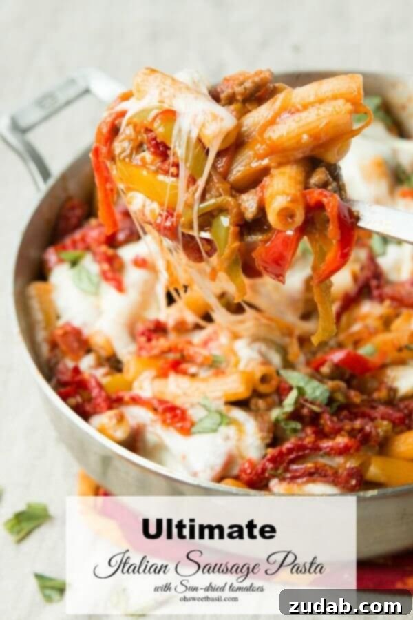 Zesty Sausage Rigatoni 4 The Ultimate Italian Sausage Pasta, a loaded pasta recipe with caramelized onions, peppers, sausage, pepperoni, and sun-dried tomatoes from Oh Sweet Basil.