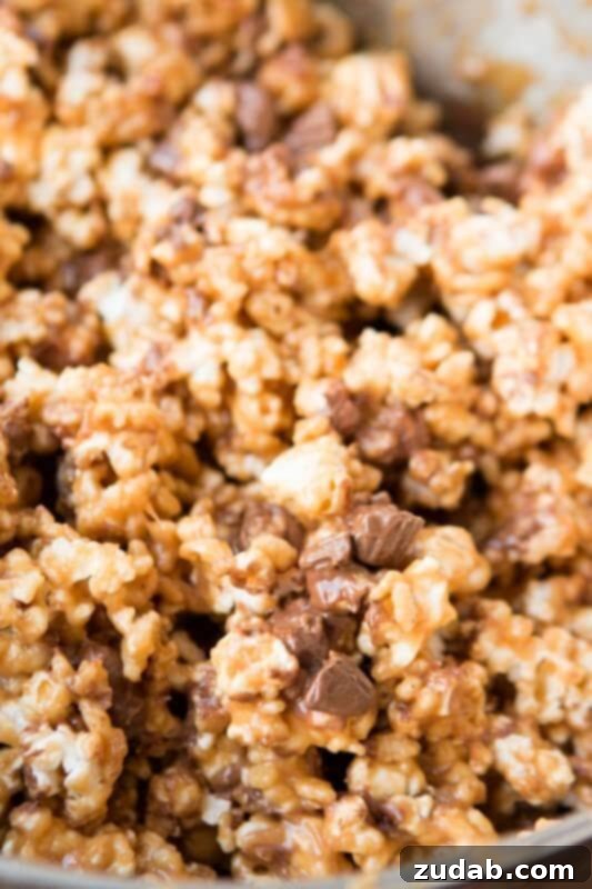 Gooey Fluffernutter Krispie Delights 5 Indulgent Reese's Krispies Popcorn, combining peanut butter and chocolate for a crunchy treat.