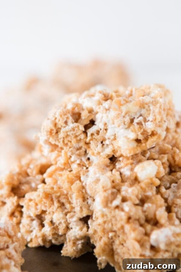 Gooey Fluffernutter Rice Krispies: The Ultimate No-Bake Peanut Butter Marshmallow Treat A stack of homemade Fluffernutter Rice Krispies, showcasing their soft, chewy layers.
