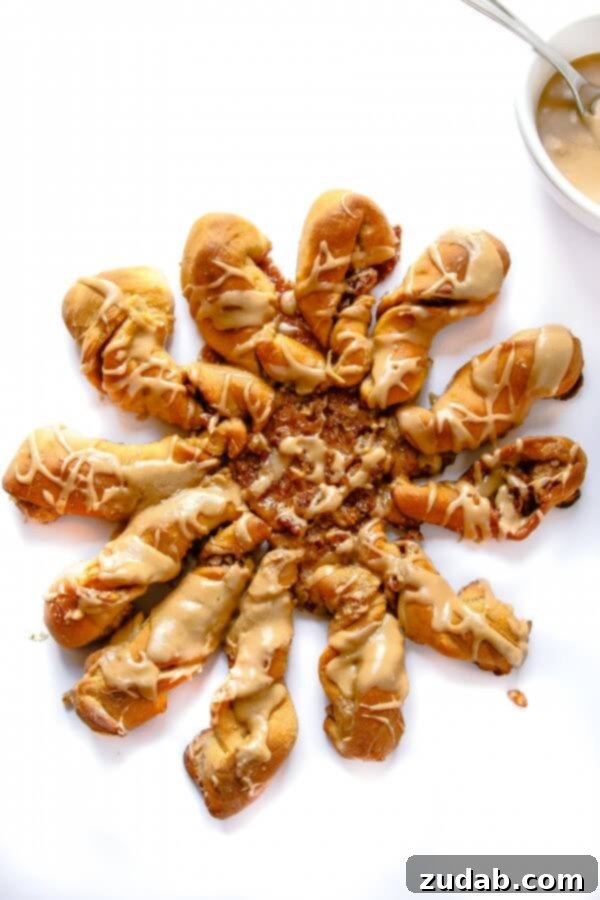 Freshly Baked Maple Twists Homemade maple cinnamon roll twists cooling on a rack before glazing.