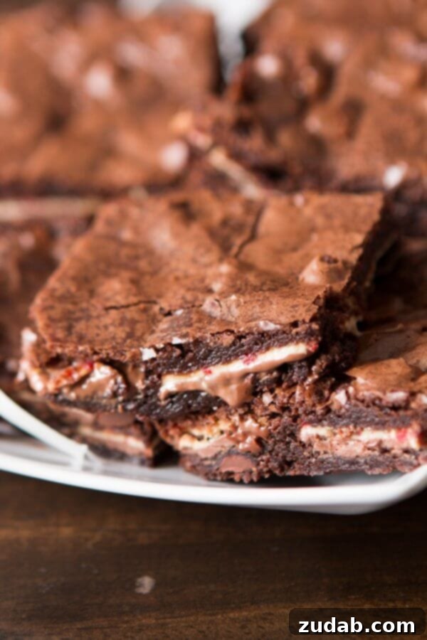 Fudgy Peppermint Bark Brownies Stack Close-up of a stack of fudgy Ghirardelli Peppermint Bark Brownies, showing the rich texture