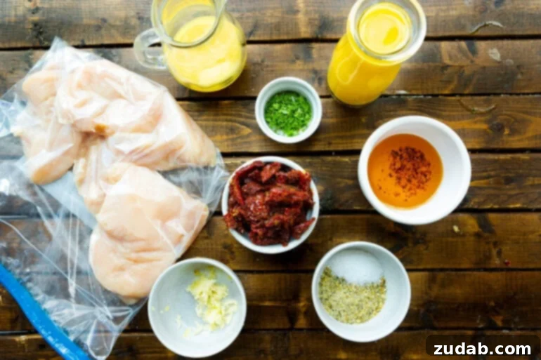 Zesty Citrus Greek Chicken 5 A vibrant flat lay photo showcasing all the fresh and aromatic ingredients used for the marinade and sauce for Citrus Greek Chicken, including oranges, garlic, and sun-dried tomatoes.
