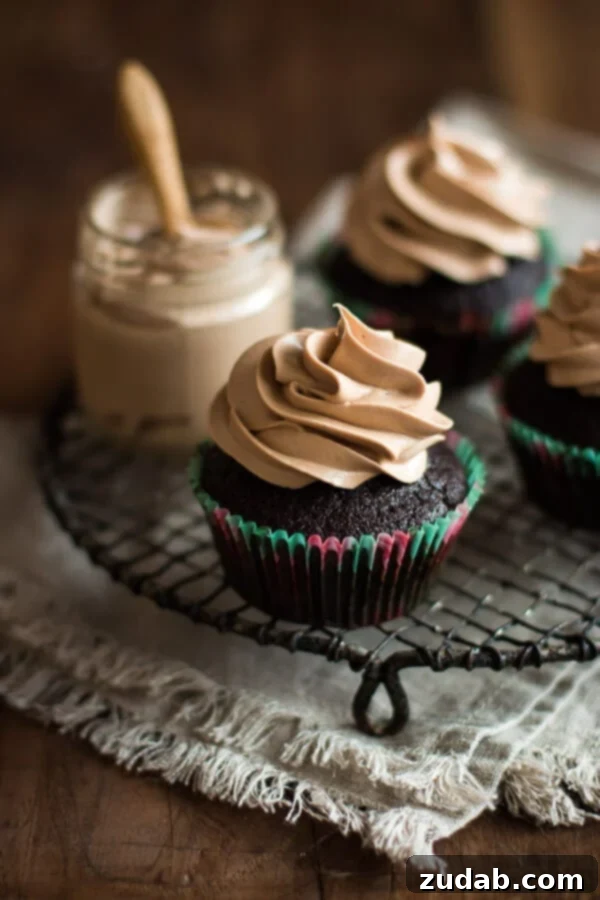 Rich Milk Chocolate Cupcakes Close-up of a perfectly frosted milk chocolate cupcake, highlighting its rich texture.
