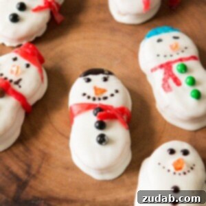 Nutter Butter Snowman Treats 3 Festive Nutter Butter Snowmen, a quick and easy no-bake treat perfect for Christmas parties.
