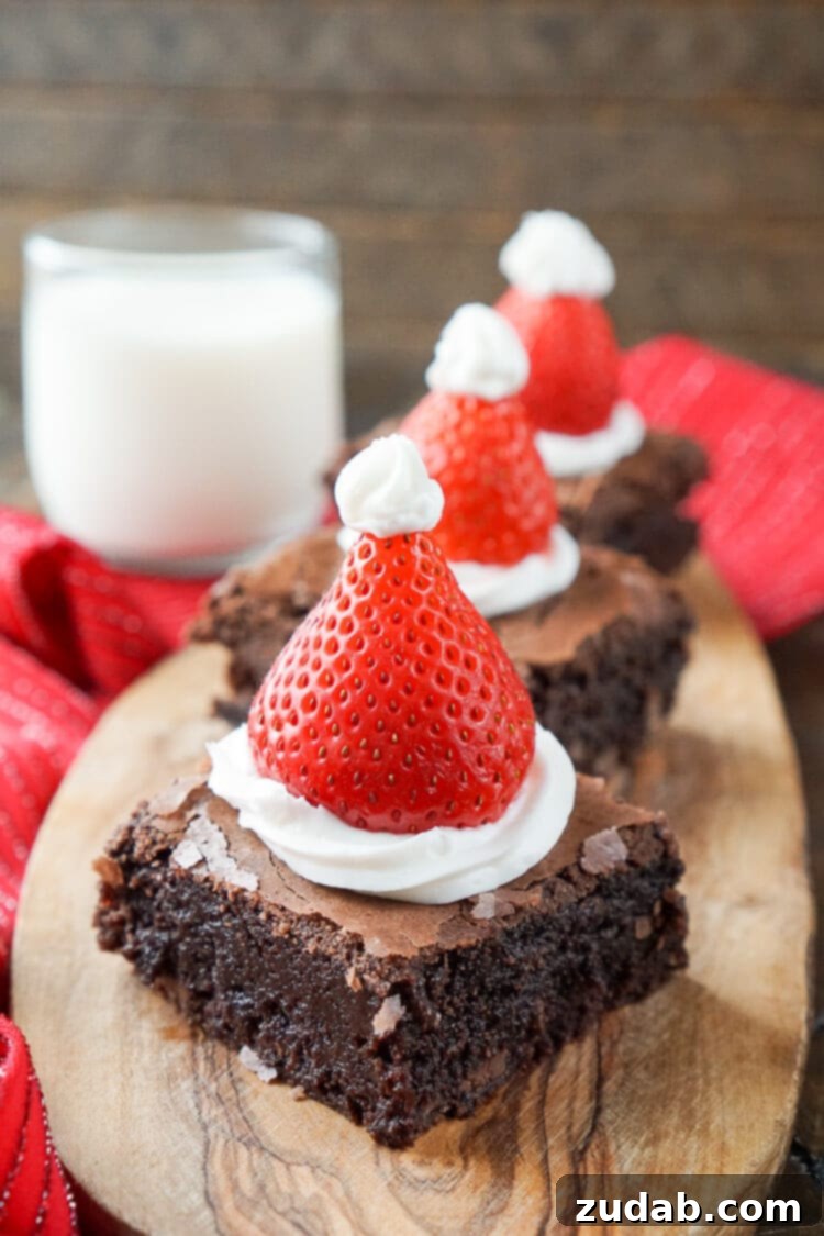 Nutter Butter Snowman Treats 6 A festive plate of Santa Hat Brownies, topped with whipped cream and a strawberry to resemble Santa's hat.