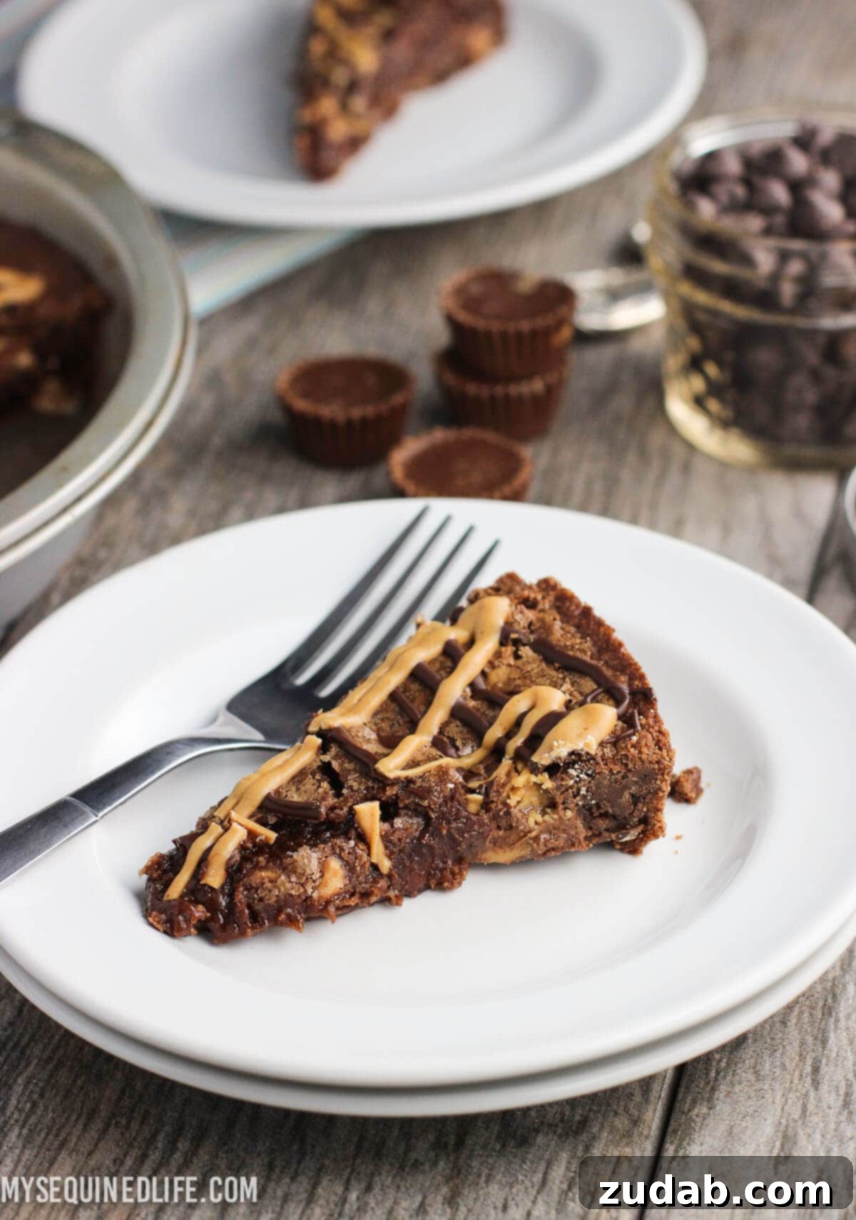 This fudgy peanut butter brownie cake recipe is a fun take on brownies! Full of chocolate and peanut butter flavor, this dessert feeds a crowd. This fudgy peanut butter brownie cake recipe is a fun take on brownies! Full of chocolate and peanut butter flavor, this dessert feeds a crowd.