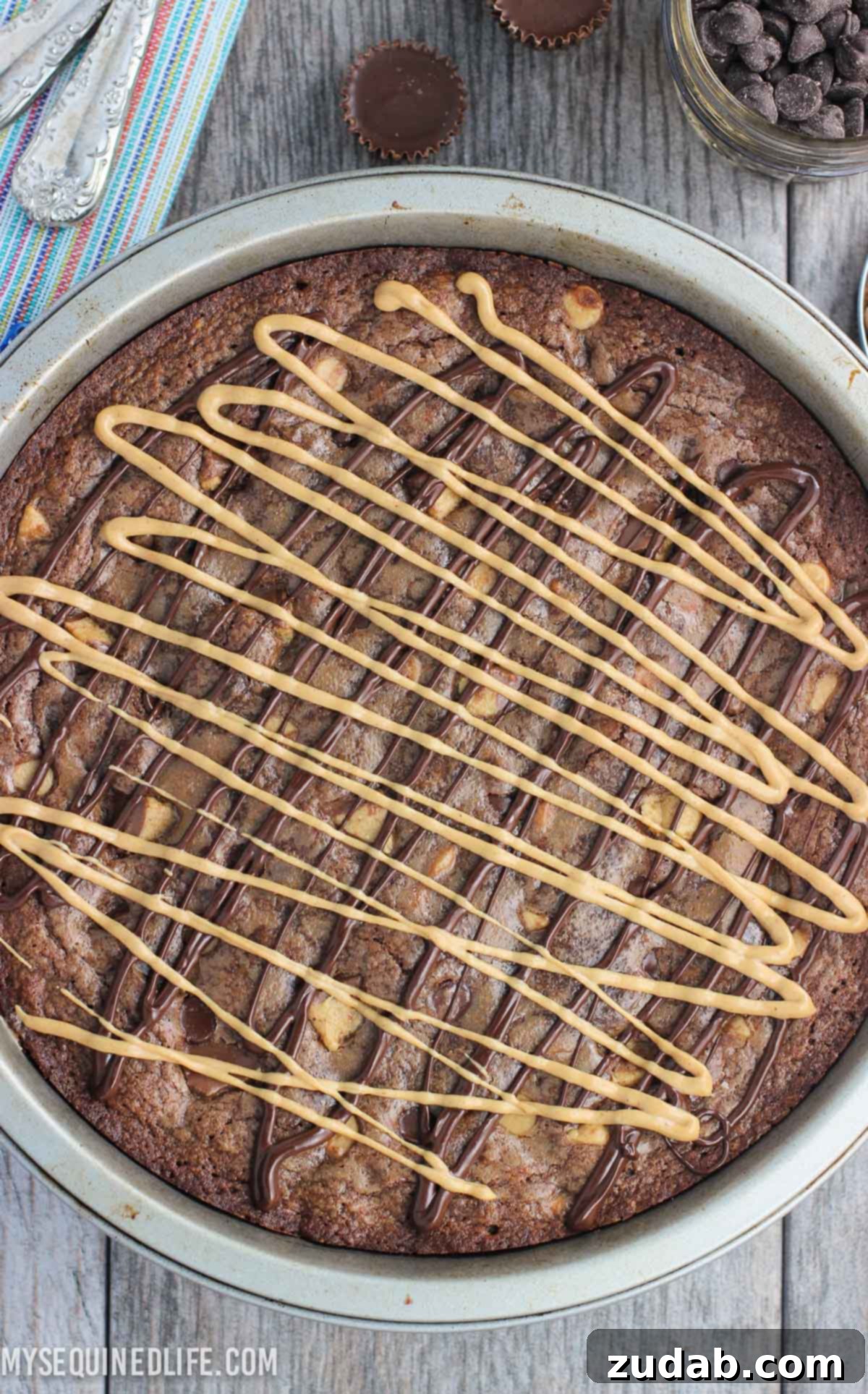This fudgy peanut butter brownie cake recipe is a fun take on brownies! Full of chocolate and peanut butter flavor, this dessert feeds a crowd. This fudgy peanut butter brownie cake recipe is a fun take on brownies! Full of chocolate and peanut butter flavor, this dessert feeds a crowd.