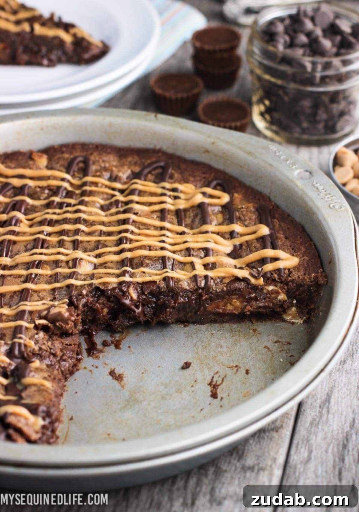 This fudgy peanut butter brownie cake recipe is a fun take on brownies! Full of chocolate and peanut butter flavor, this dessert feeds a crowd. This fudgy peanut butter brownie cake recipe is a fun take on brownies! Full of chocolate and peanut butter flavor, this dessert feeds a crowd.